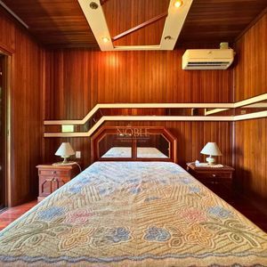 Casa com 220m², 4 dormitórios, 4 suítes, 2 vagas no bairro Igra Norte em Torres para Comprar