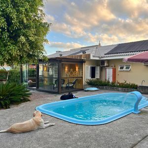 Casa com 184m², 3 dormitórios, 1 suíte, 2 vagas no bairro Igra Norte em Torres para Comprar