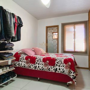 Casa com 102m², 2 dormitórios, 1 suíte, 2 vagas no bairro Igra Sul em Torres para Comprar