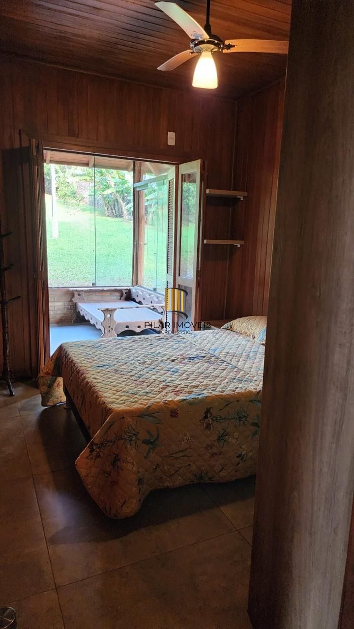 Casa com 2 dormitórios, piscina em terreno totalmente arborizado.