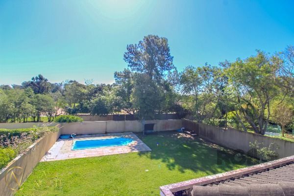 Casa de Condomínio à venda com 4 quartos, 405m², 4 suítes, 1 vaga, Avenida Juca Batista no bairro Chapéu do Sol em Porto Alegre