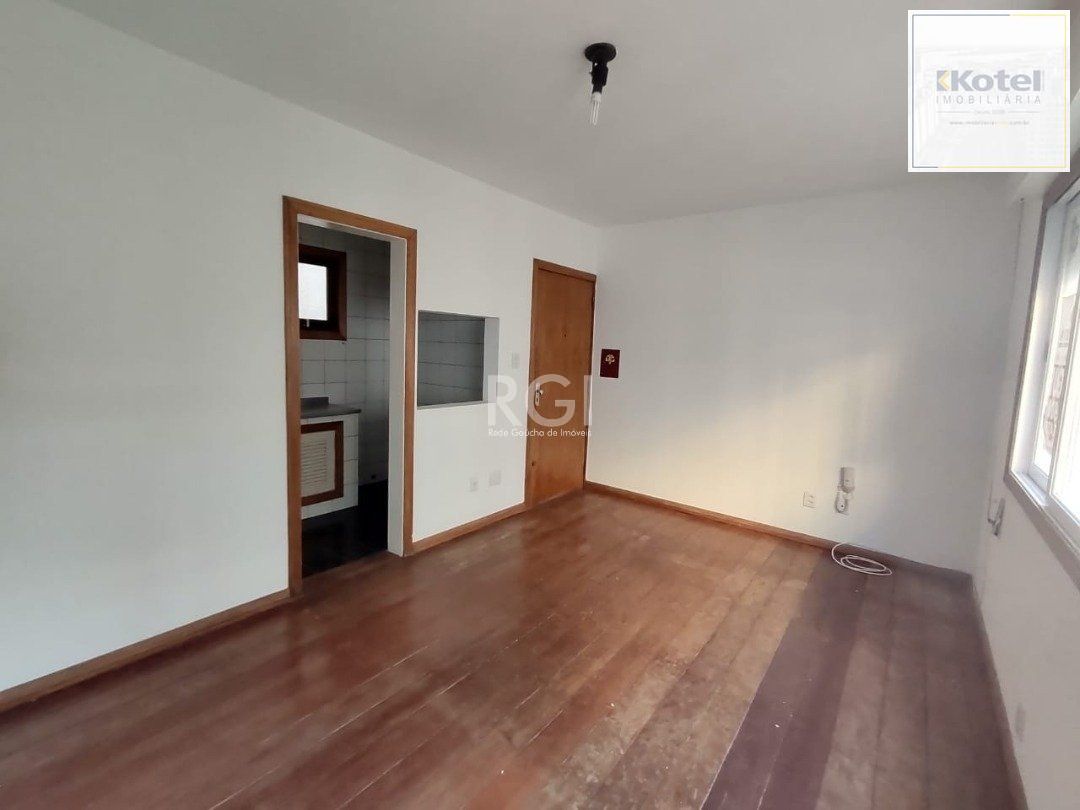 JK no Centro Histórico de Porto Alegre, com 26,01 m², cozinha com pia e armários, banheiro com box, piso com tabuão e orientação solar leste (sol da manhã).