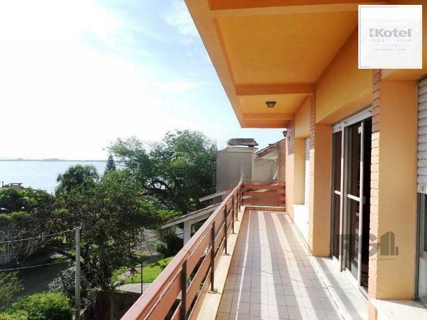 residência com vista panorâmica espetacular para o Guaíba em todos os cômodos da casa, hall de entrada, gabinete, lavabo, living para três ambientes com sacada e vista — foto 3