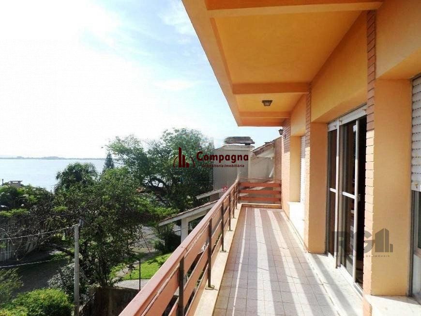 residência com vista panorâmica espetacular para o Guaíba em todos os cômodos da casa, hall de entrada, gabinete, lavabo, living para três ambientes com sacada e vista — foto 3