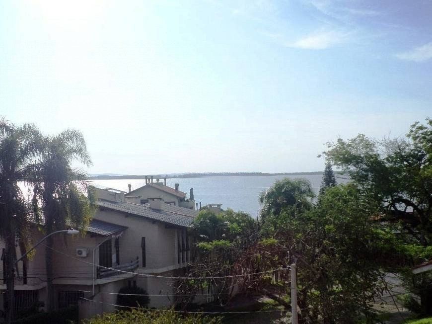 residência com vista panorâmica espetacular para o Guaíba em todos os cômodos da casa, hall de entrada, gabinete, lavabo, living para três ambientes com sacada e vista — foto 5