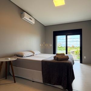 Casa, 2 dormitórios, 2 suítes, 1 vaga no bairro Morada das Palmeiras em Torres para Comprar