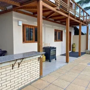 Casa com 272m², 4 dormitórios, 1 suíte, 3 vagas no bairro Igra Norte em Torres para Comprar