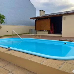 Casa com 272m², 4 dormitórios, 1 suíte, 3 vagas no bairro Igra Norte em Torres para Comprar