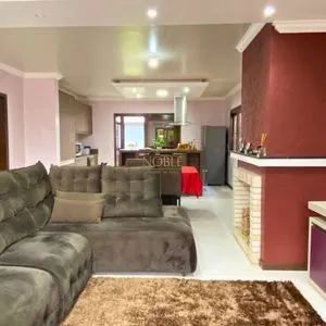 Casa com 148m², 3 dormitórios, 1 suíte, 2 vagas no bairro Morada das Palmeiras em Torres para Comprar