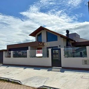 Casa com 215m², 3 dormitórios, 1 suíte, 2 vagas no bairro Morada das Palmeiras em Torres para Comprar