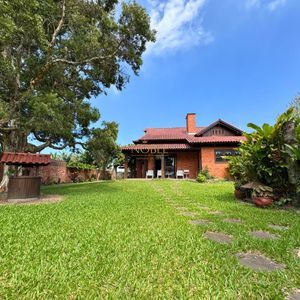 Casa com 220m², 4 dormitórios, 4 suítes, 2 vagas no bairro Igra Norte em Torres para Comprar