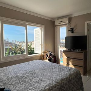 Sobrado com 290m², 4 dormitórios, 1 suíte, 2 vagas no bairro Igra Norte em Torres para Comprar